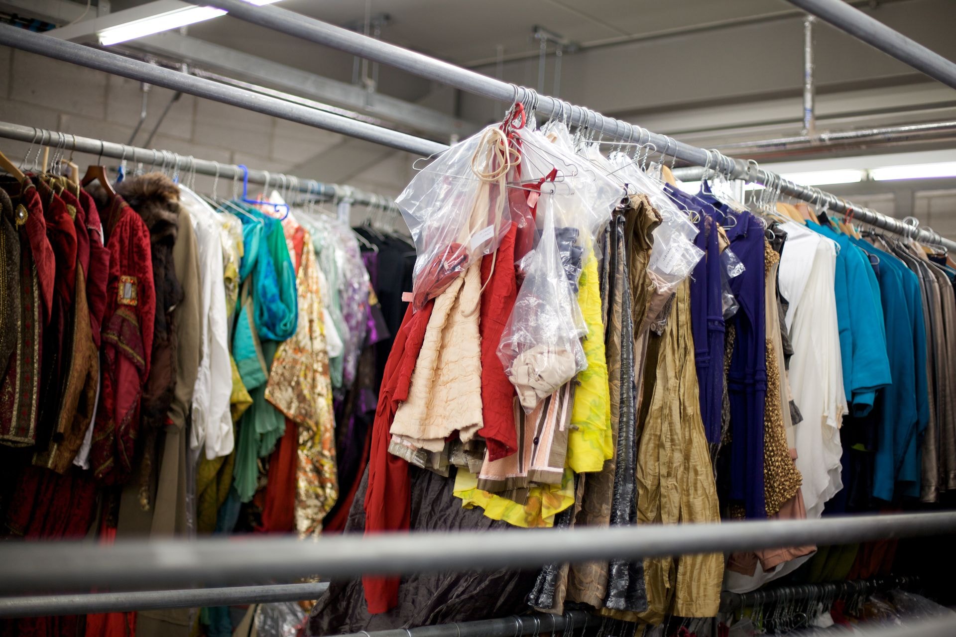 Wedding dresses and costumes hanging on boutique rack