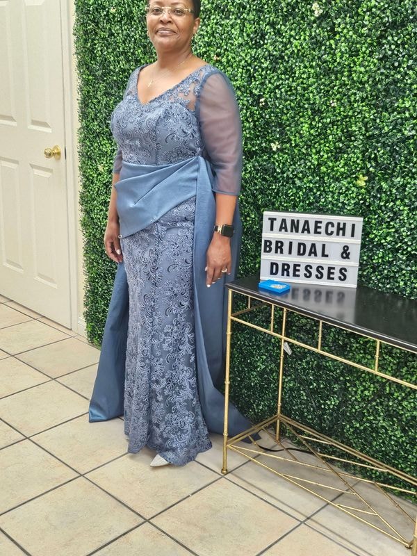 Five light blue bridesmaid dresses hanging