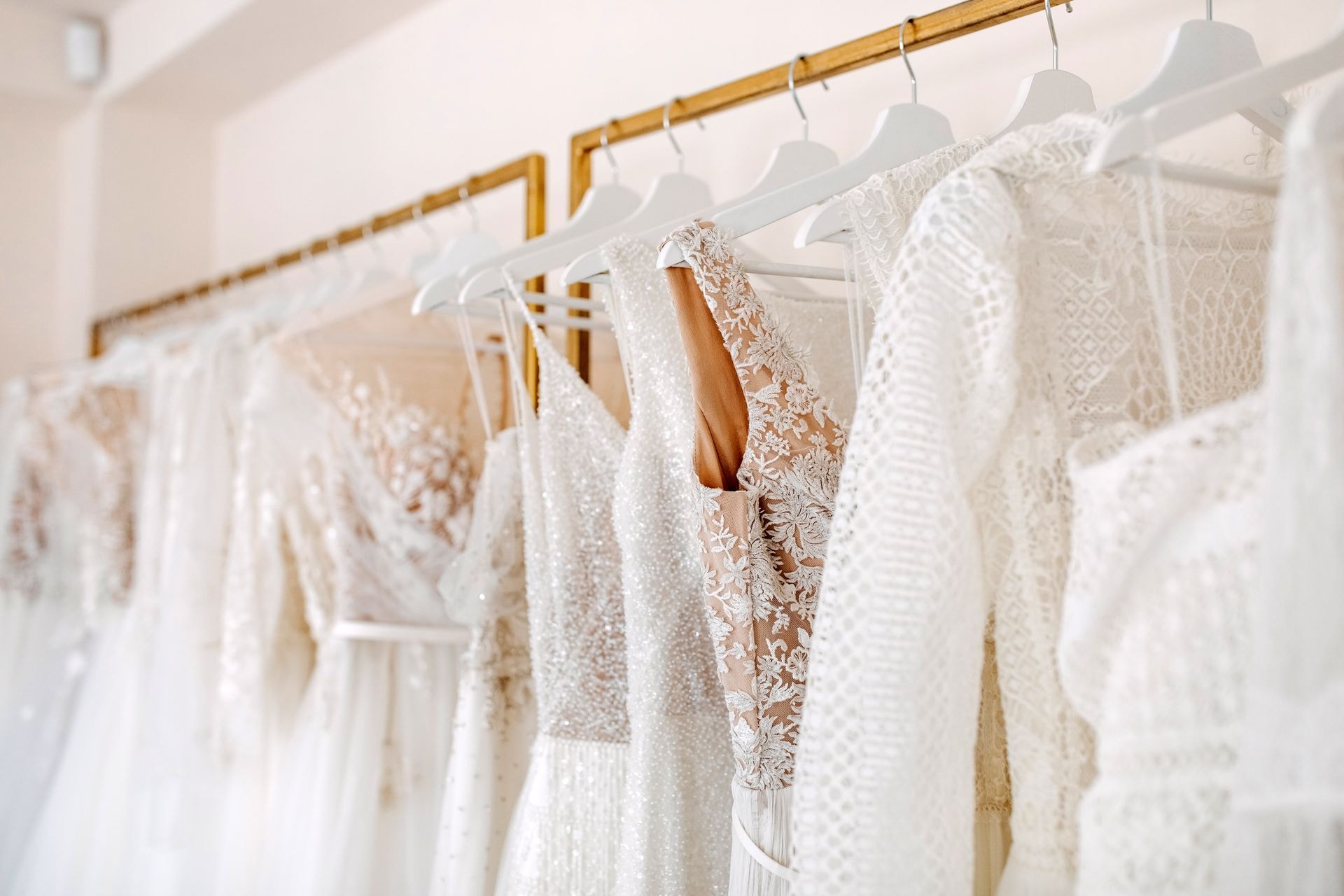 Bridal gowns hanging in boutique