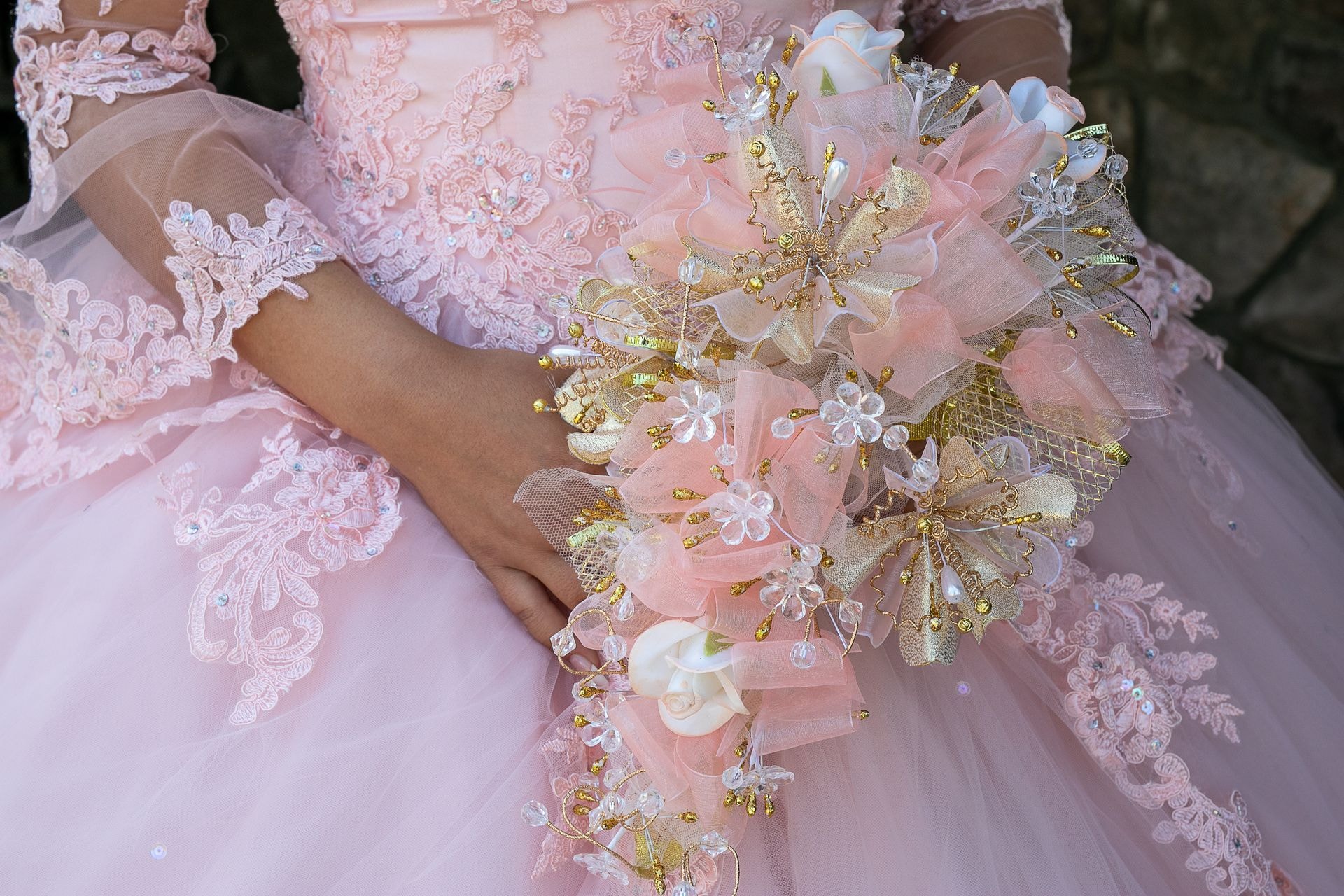 Custom quinceañera gown with ornate gold floral details