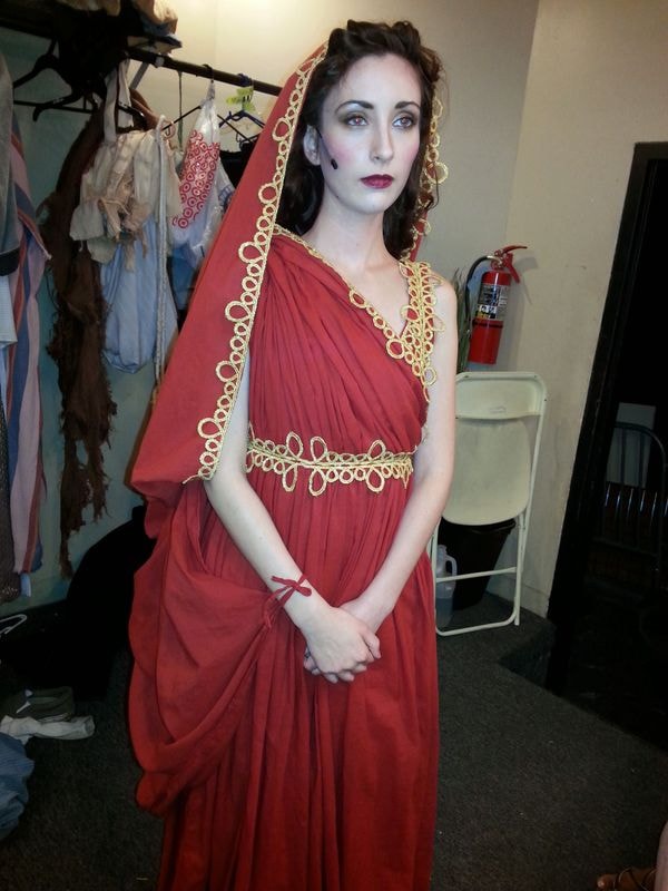 Woman wearing red Roman toga costume